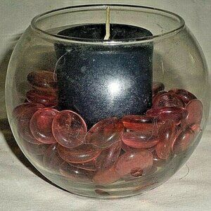 ARTISAN-CRAFTED Navy candle amid shiny pink glass pebbles in round bowl